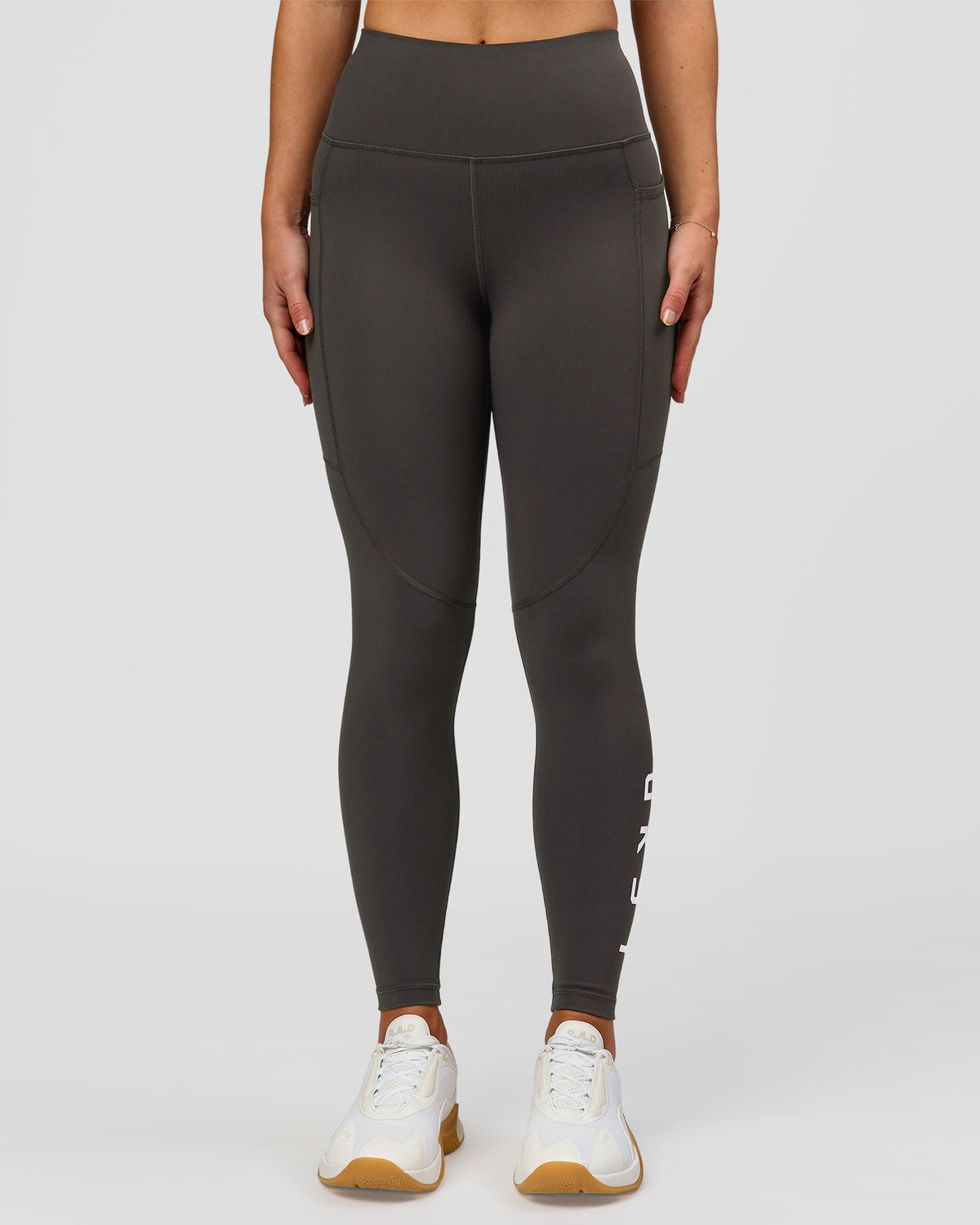 Woman wearing Rep Ultra High-Rise 7/8 Legging Pockets - Onyx-white | Model:Issy | Size:XS