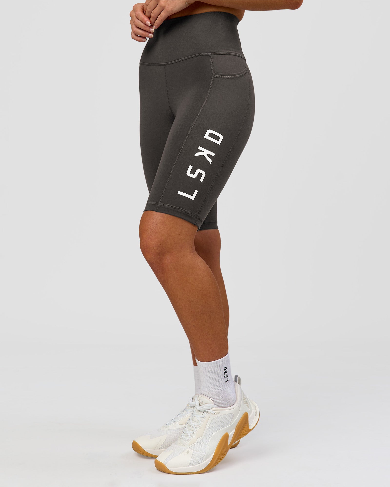Woman wearing Rep Ultra High-Rise 9" Short Pockets - Onyx-white | Model:Issy | Size:XS