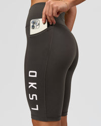 Woman wearing Rep Ultra High-Rise 9" Short Pockets - Onyx-white | Model:Issy | Size:XS | Thumbnail Index: 1