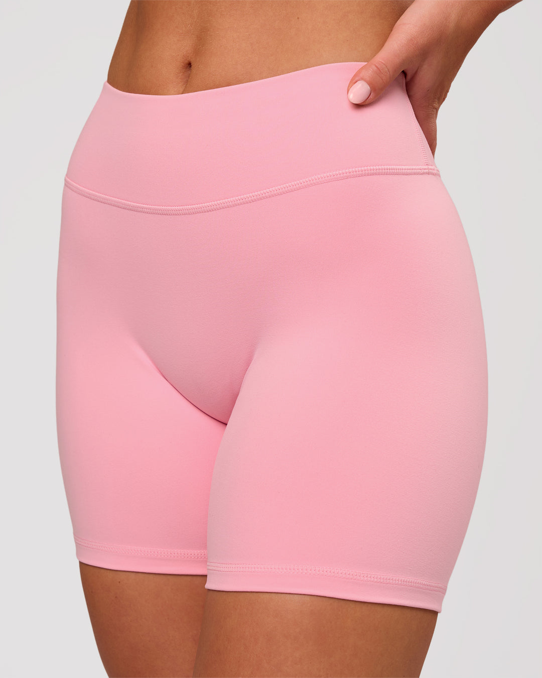 Woman wearing RXD Mid-Rise 6" Short - Pink Rose | Model:Issy | Size:XS - view 1