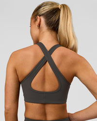 Woman wearing Stamina Sports Bra - Onyx | Model:Issy | Size:XS | Thumbnail Index: 3