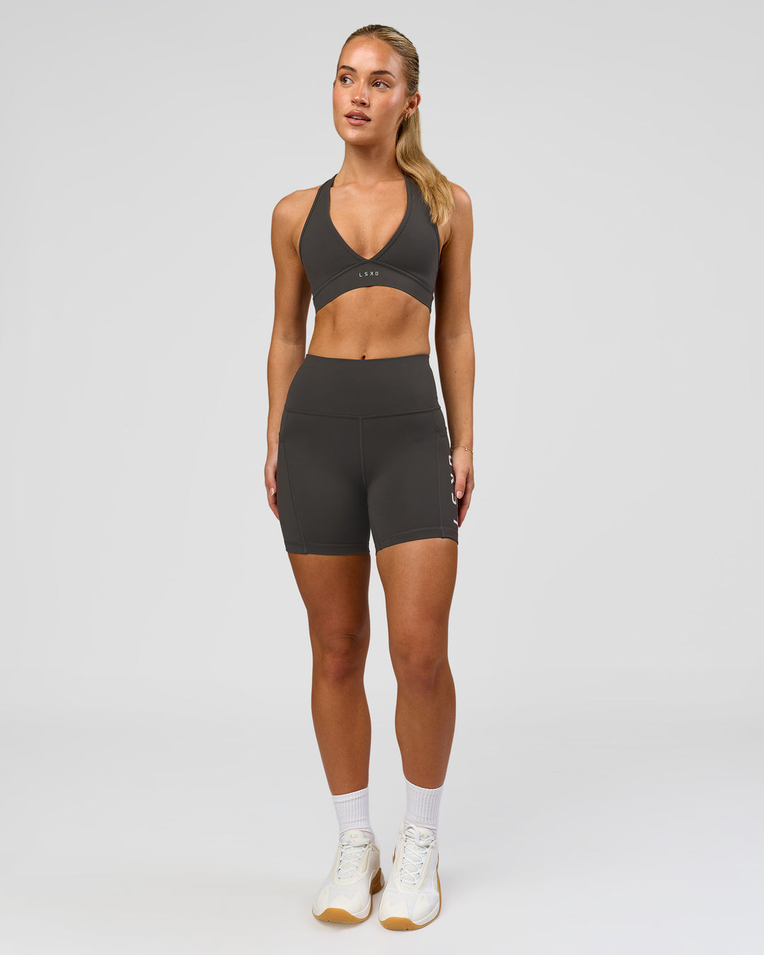 Woman wearing Stamina Sports Bra - Onyx | Model:Issy | Size:XS - view 5