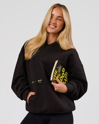 Woman wearing TGHF X LSKD 26 Oversized Hoodie - Black | Model:Issy | Size:XS | Thumbnail Index: 3