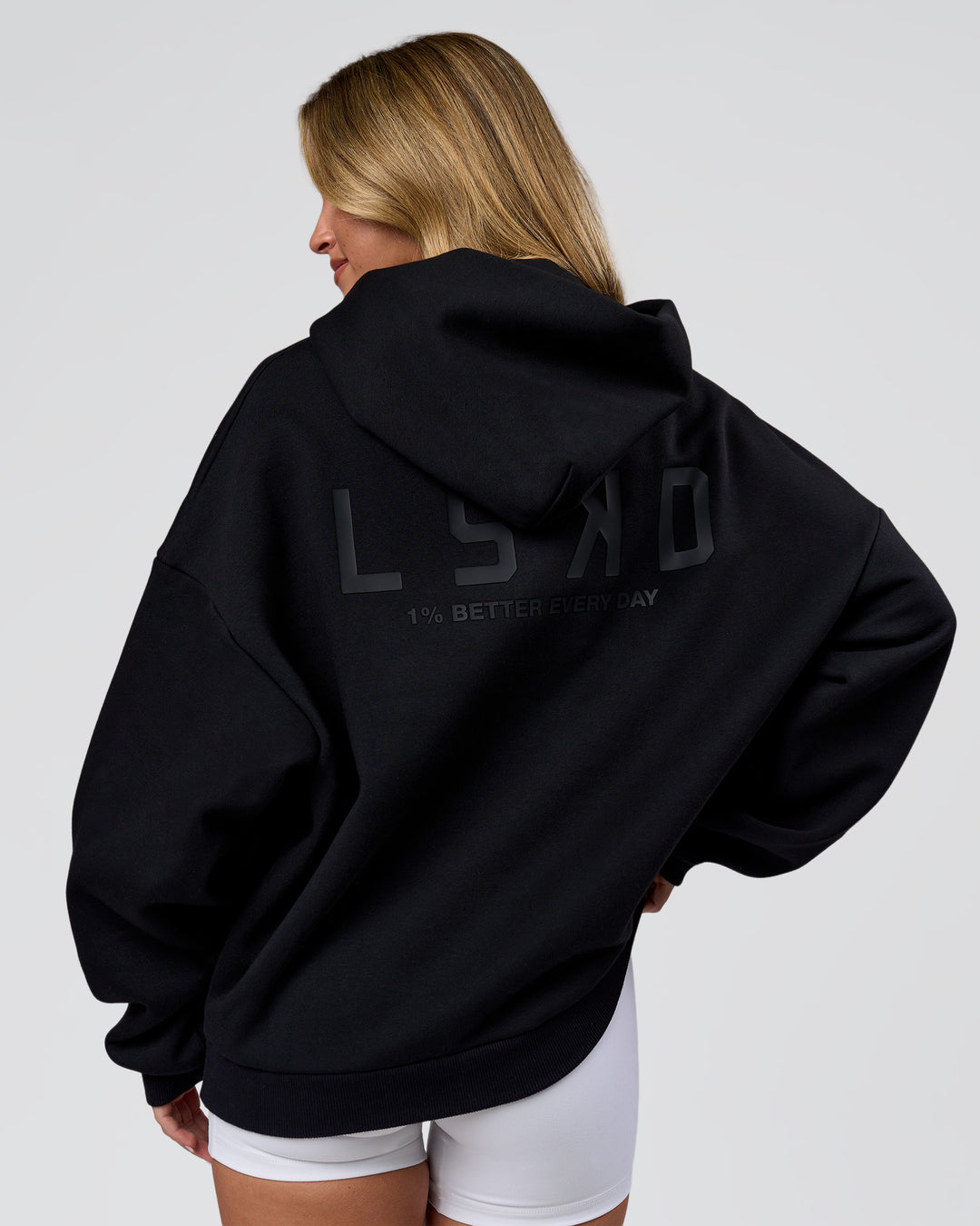 Woman wearing Tonal Legacy Boxy Hoodie - Black-Black | Model:Issy | Size:XS - view 3