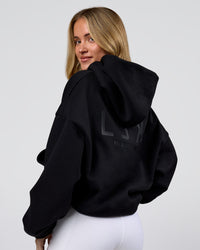 Woman wearing Tonal Legacy Boxy Hoodie - Black-Black | Model:Issy | Size:XS | Thumbnail Index: 8
