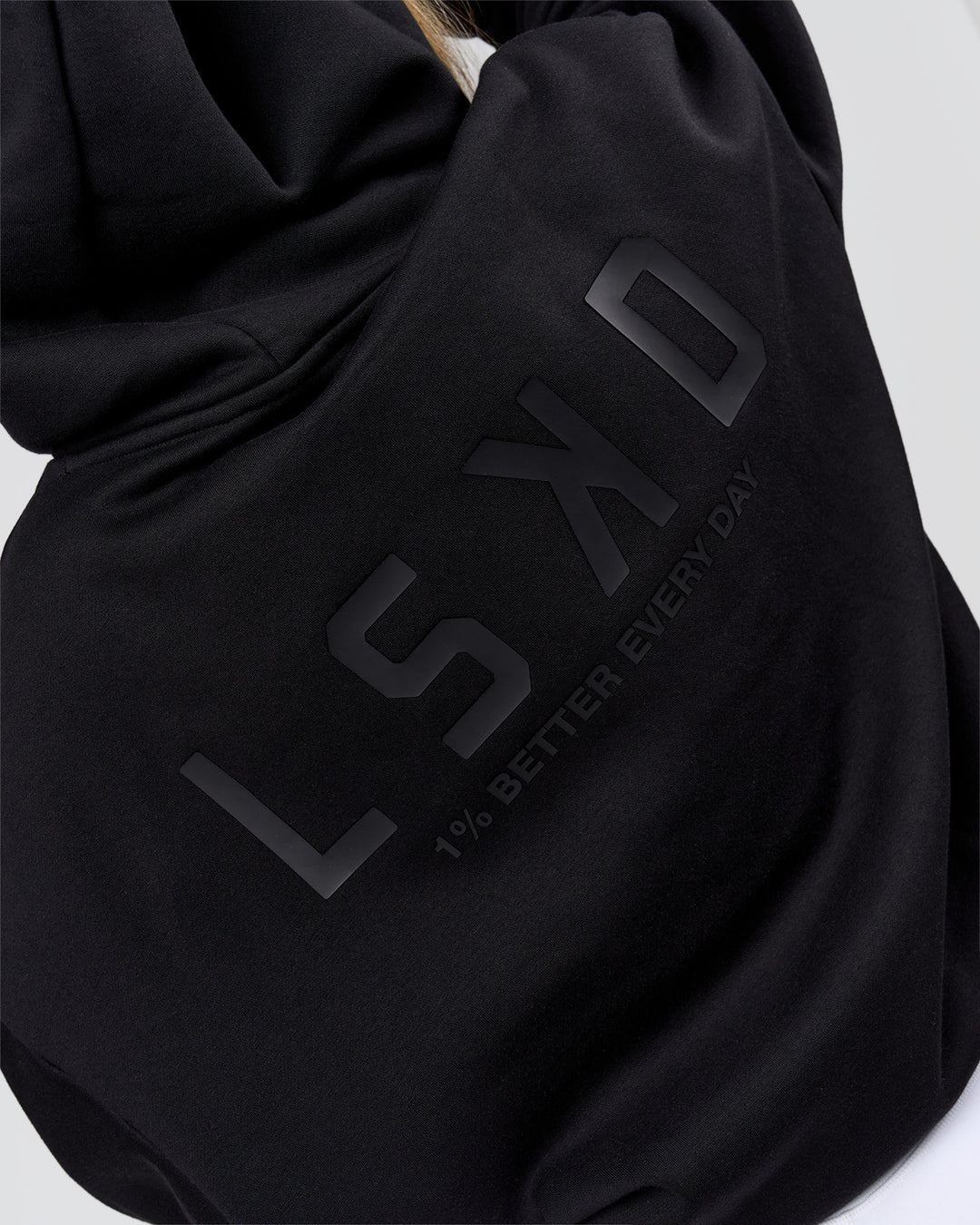 Woman wearing Tonal Legacy Boxy Hoodie - Black-Black | Model:Issy | Size:XS - view 11