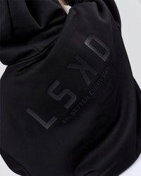 Woman wearing Tonal Legacy Boxy Hoodie - Black-Black | Model:Issy | Size:XS | Thumbnail Index: 10