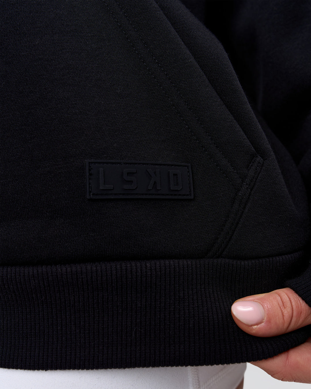 Woman wearing Tonal Legacy Boxy Hoodie - Black-Black | Model:Issy | Size:XS - view 17