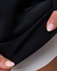 Woman wearing Tonal Legacy Boxy Hoodie - Black-Black | Model:Issy | Size:XS | Thumbnail Index: 18
