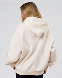 Woman wearing Tonal Legacy Boxy Hoodie - Off White-Off White | Model:Issy | Size:XS | Thumbnail Index: 2