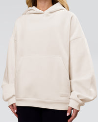 Woman wearing Tonal Legacy Boxy Hoodie - Off White-Off White | Model:Issy | Size:XS | Thumbnail Index: 11