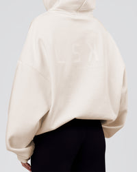 Woman wearing Tonal Legacy Boxy Hoodie - Off White-Off White | Model:Issy | Size:XS | Thumbnail Index: 13