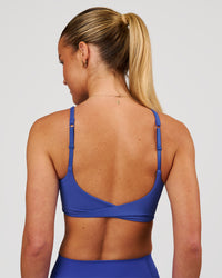 Woman wearing Twist Sports Bra - Power Cobalt | Model:Issy | Size:XS | Thumbnail Index: 4