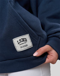 Woman wearing Varsity Boxy Hoodie - Future Navy-White | Model:Issy | Size:XS | Thumbnail Index: 20