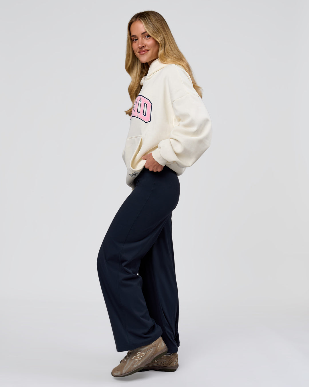 Woman wearing Varsity Boxy Hoodie - Off White-Pink Rose | Model:Issy | Size:XS - view 20