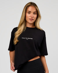 Woman wearing VS1 Enjoy The Journey FLXCotton Oversize Tee - Black | Model:Issy | Size:XS | Thumbnail Index: 3