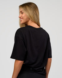 Woman wearing VS1 Enjoy The Journey FLXCotton Oversize Tee - Black | Model:Issy | Size:XS | Thumbnail Index: 5