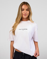 Woman wearing VS1 Enjoy The Journey FLXCotton Oversize Tee - White | Model:Issy | Size:XS | Thumbnail Index: 2