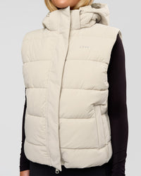 Woman wearing Go-To Puffer Vest - Shale Beige | Model:Izzy | Size:XS | Thumbnail Index: 0