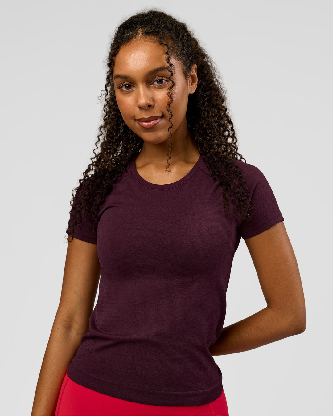 Woman wearing AeroFLX+ Seamless Tee - Cherry Lacquer/Cherry Lacquer | Model:Jordan | Size:XS - view 1