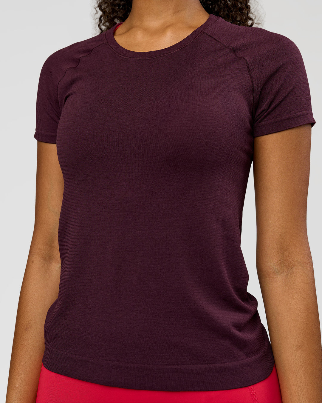 Woman wearing AeroFLX+ Seamless Tee - Cherry Lacquer/Cherry Lacquer | Model:Jordan | Size:XS - view 3
