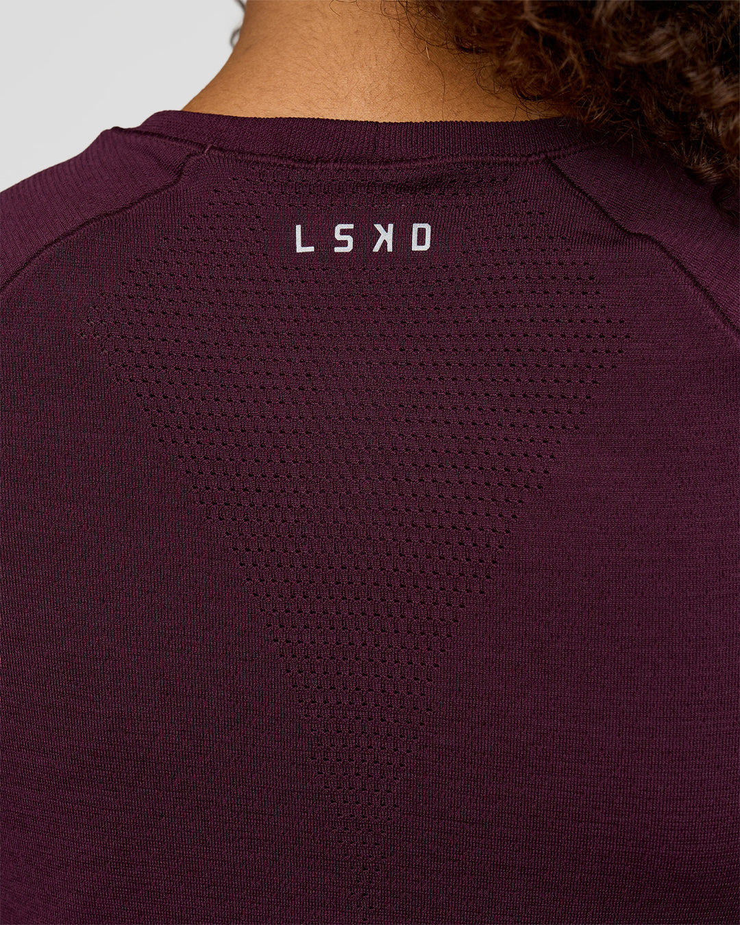 Woman wearing AeroFLX+ Seamless Tee - Cherry Lacquer/Cherry Lacquer | Model:Jordan | Size:XS - view 6