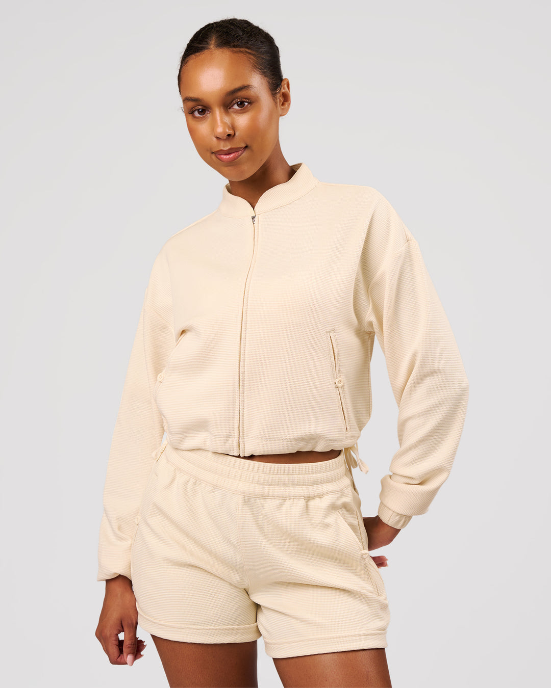 Woman wearing CloudWaffle Midi Zip Up - Vanilla Bean | Model:Jordan | Size:XS - view 1