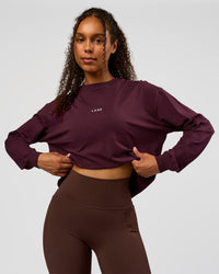 Woman wearing Go-To Long Sleeve FLXCotton Oversized Tee - Cherry Lacquer-White | Model:Jordan | Size:XS | Thumbnail Index: 0