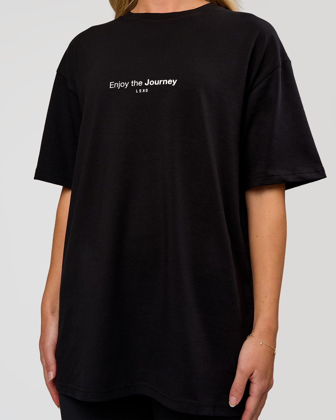 Woman wearing VS1 Enjoy The Journey FLXCotton Oversize Tee - Black | Model:Leandro | Size:XS - view 13