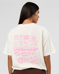 Woman wearing Built On Values FLXCotton Oversized Tee - Off White-Pink Rose | Model:Rhiley | Size:XS | Thumbnail Index: 1