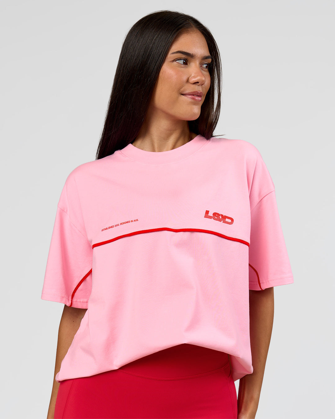 Woman wearing Inline Heavyweight FLXCotton Oversized Tee - Pink Rose-Flame | Model:Rhiley | Size:XS - view 6
