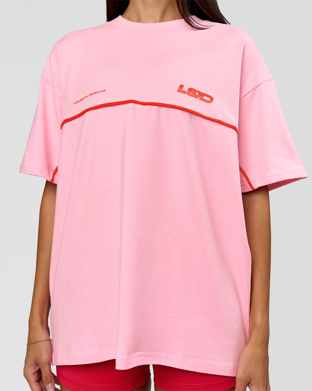 Woman wearing Inline Heavyweight FLXCotton Oversized Tee - Pink Rose-Flame | Model:Rhiley | Size:XS - view 21
