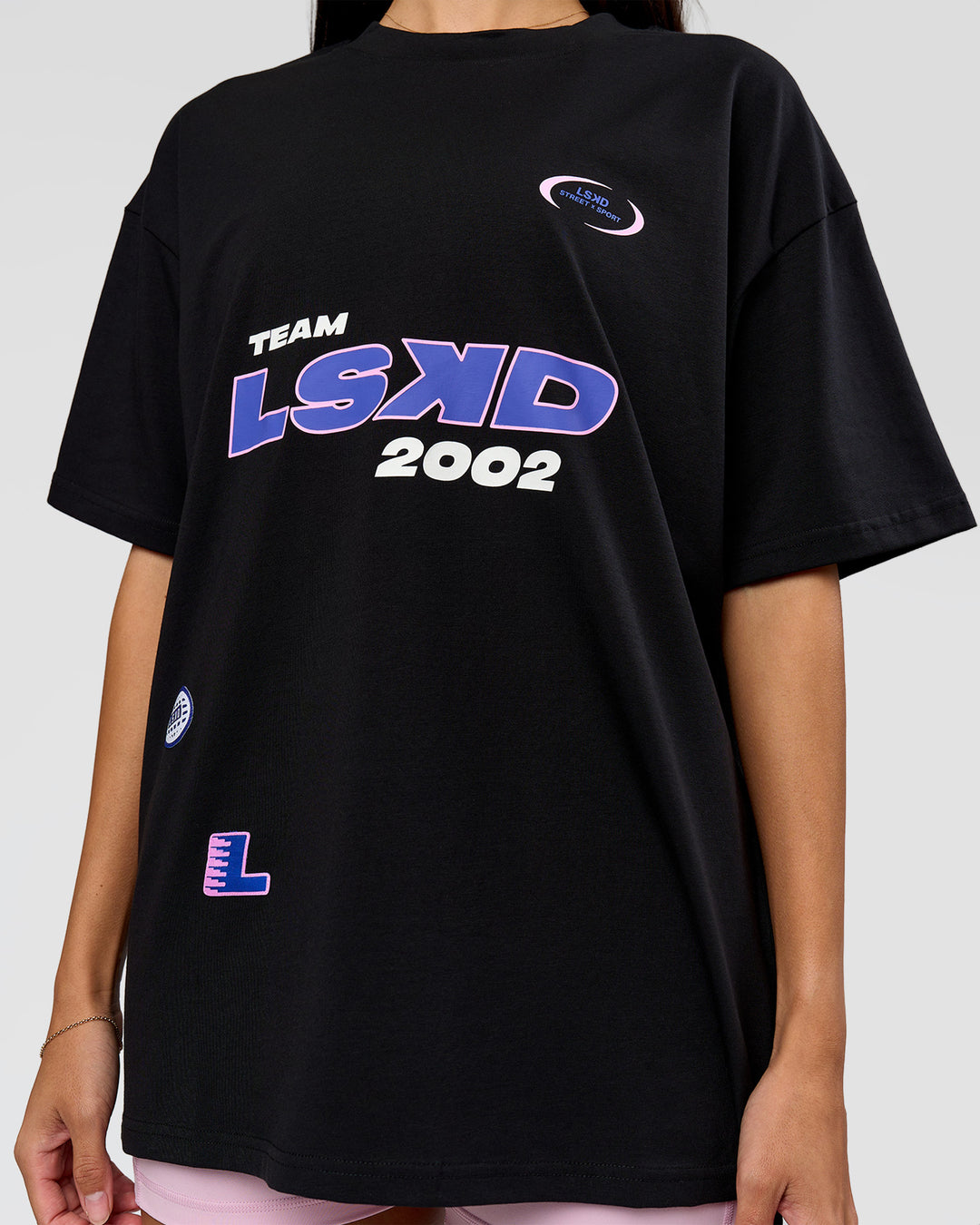 Woman wearing League Heavyweight FLXCotton Oversized Tee - Black-Power Cobalt | Model:Rhiley | Size:XS - view 4