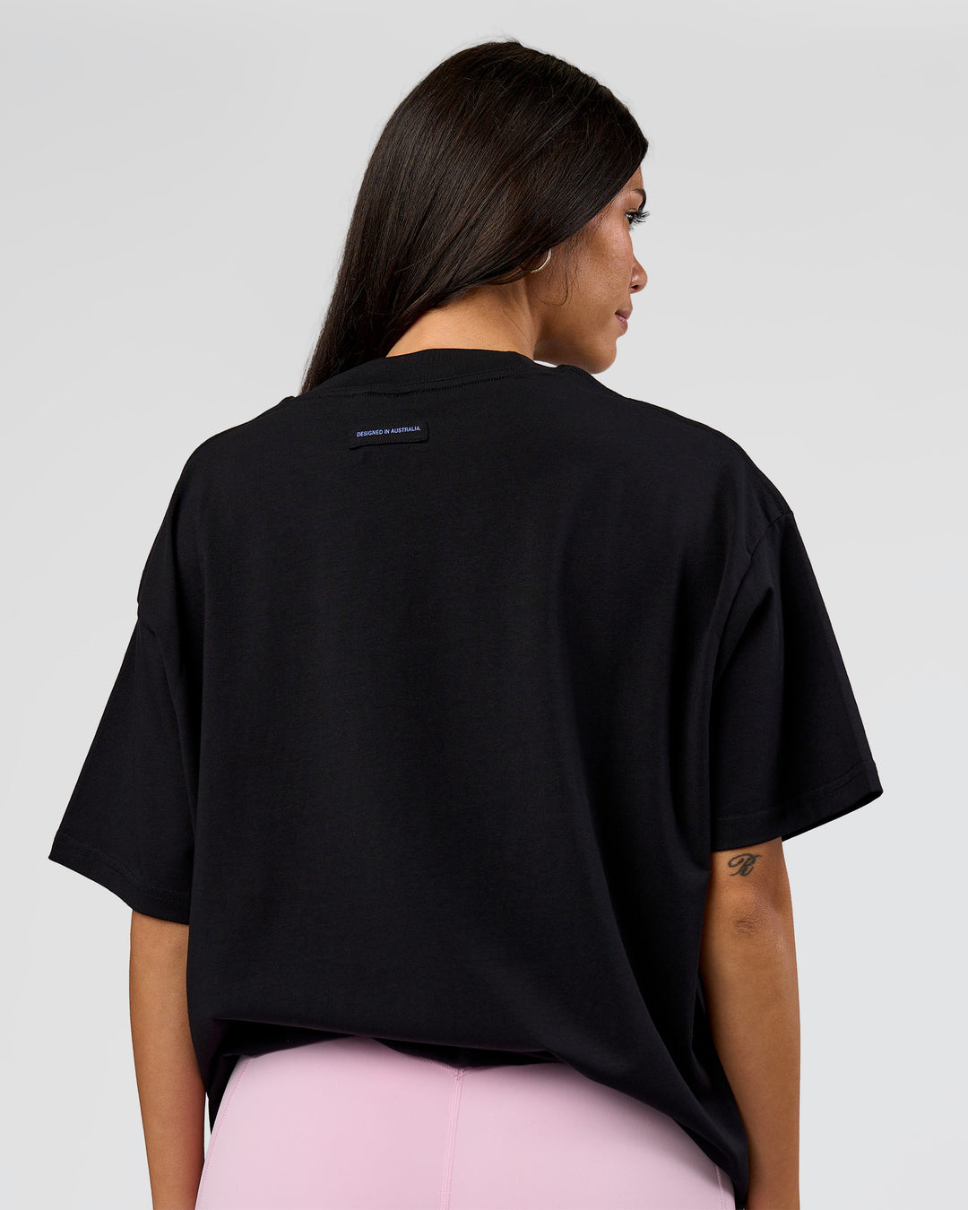 Woman wearing League Heavyweight FLXCotton Oversized Tee - Black-Power Cobalt | Model:Rhiley | Size:XS - view 15