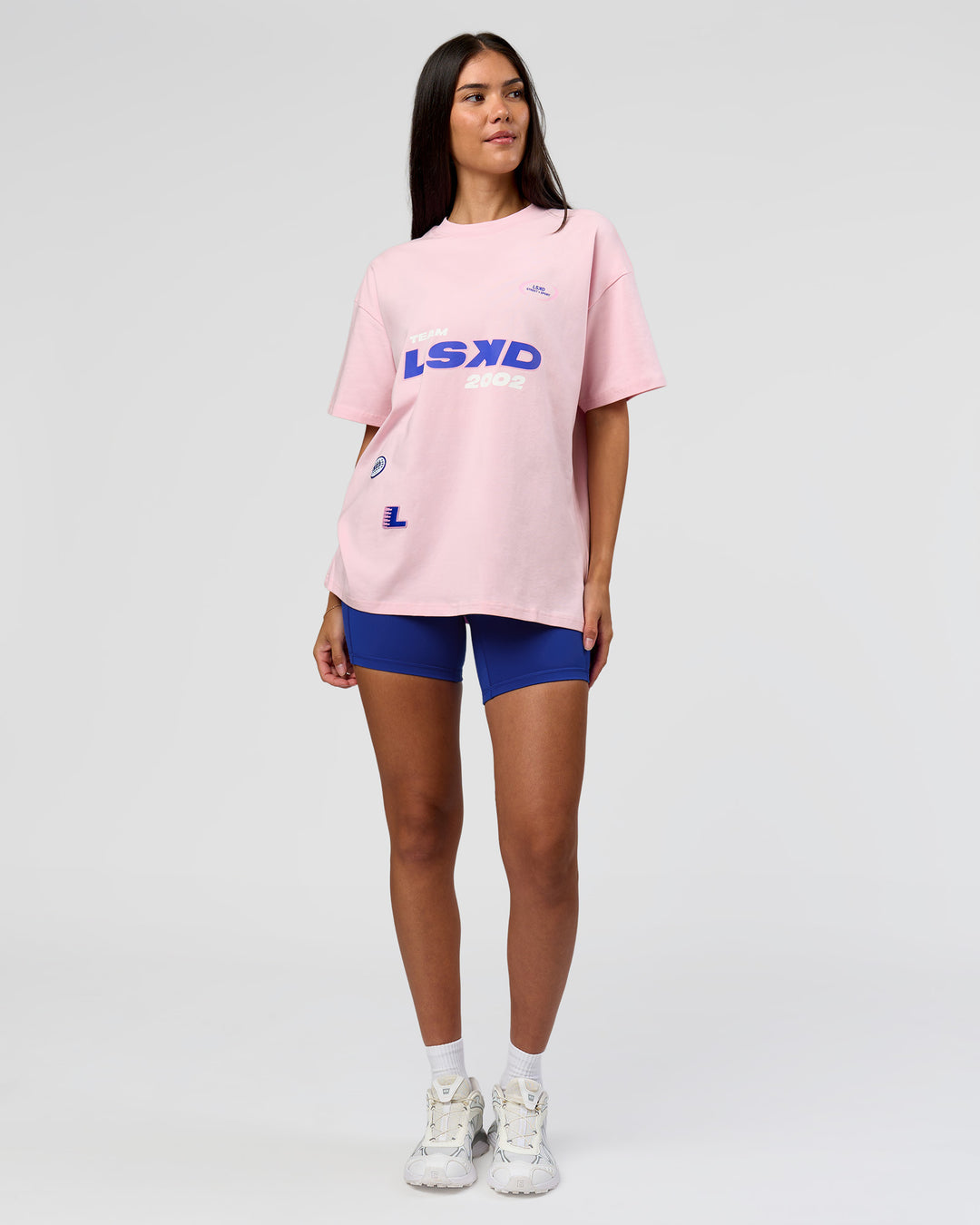 Woman wearing League Heavyweight FLXCotton Oversized Tee - Marshmallow-Power Cobalt | Model:Rhiley | Size:XS - view 9