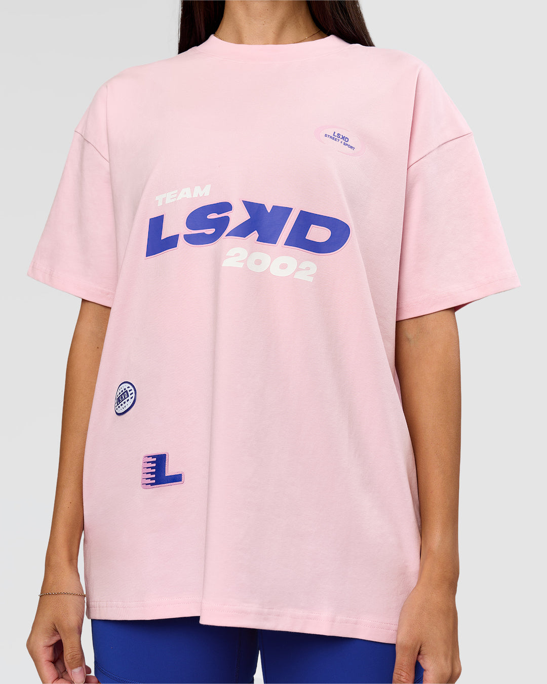 Woman wearing League Heavyweight FLXCotton Oversized Tee - Marshmallow-Power Cobalt | Model:Rhiley | Size:XS - view 6