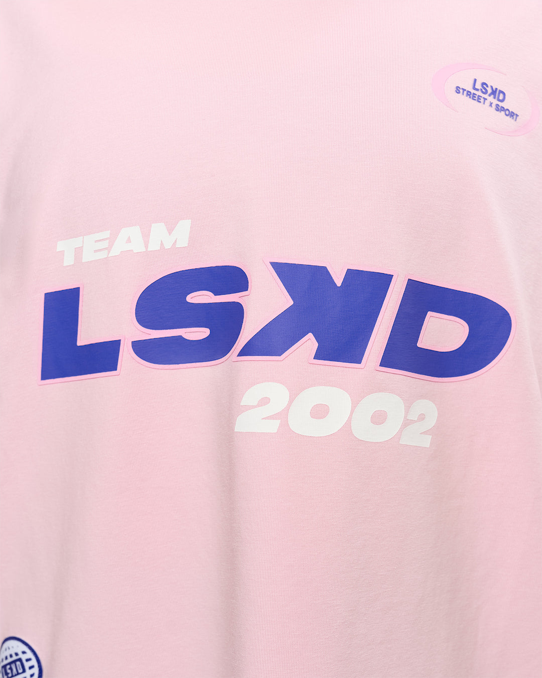 Woman wearing League Heavyweight FLXCotton Oversized Tee - Marshmallow-Power Cobalt | Model:Rhiley | Size:XS - view 18