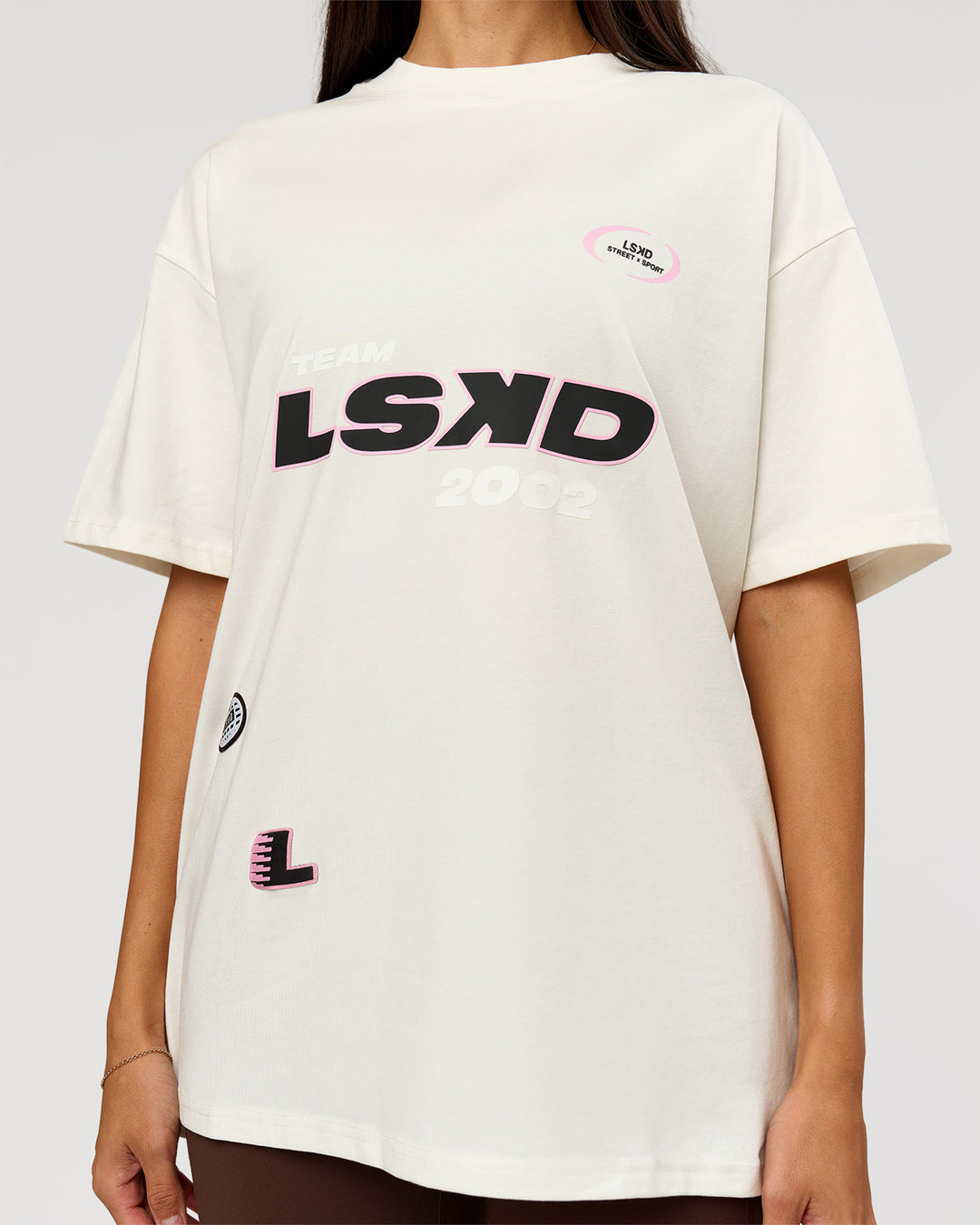 Woman wearing League Heavyweight FLXCotton Oversized Tee - Off White-Ground Coffee | Model:Rhiley | Size:XS - view 11