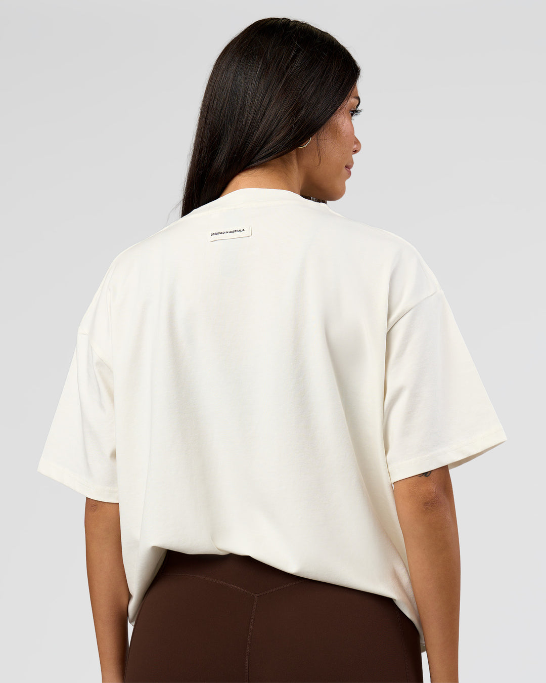 Woman wearing League Heavyweight FLXCotton Oversized Tee - Off White-Ground Coffee | Model:Rhiley | Size:XS - view 15