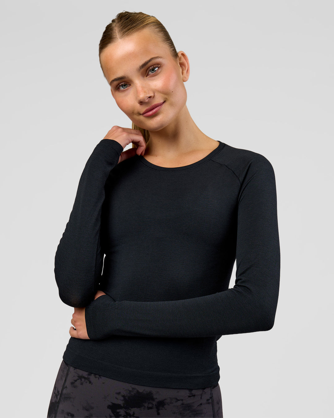 Woman wearing AeroFLX+ Seamless Long Sleeve Tee - Black Marl | Model:Taneisha | Size:XS - view 1