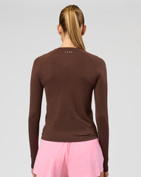 Woman wearing AeroFLX+ Seamless Long Sleeve Tee - Hot Chocolate/Hot Chocolate | Model:Taneisha | Size:XS | Thumbnail Index: 3