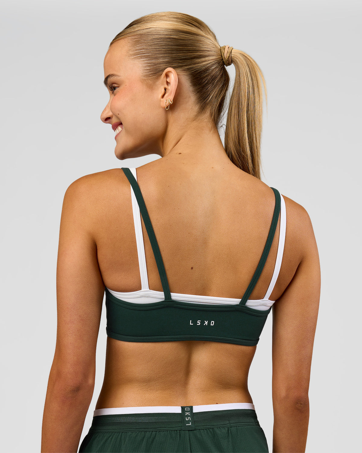 Woman wearing Balance Sports Bra - Midnight Green-White | Model:Taneisha | Size:XS - view 2