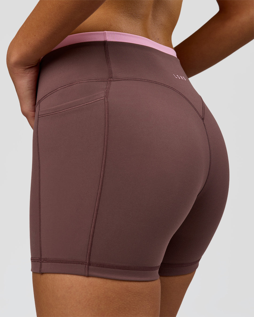 Woman wearing Bree Fusion High-Rise 4" Short Pockets - Cocoa Powder-Pink Rose | Model:Taneisha | Size:XS - view 12