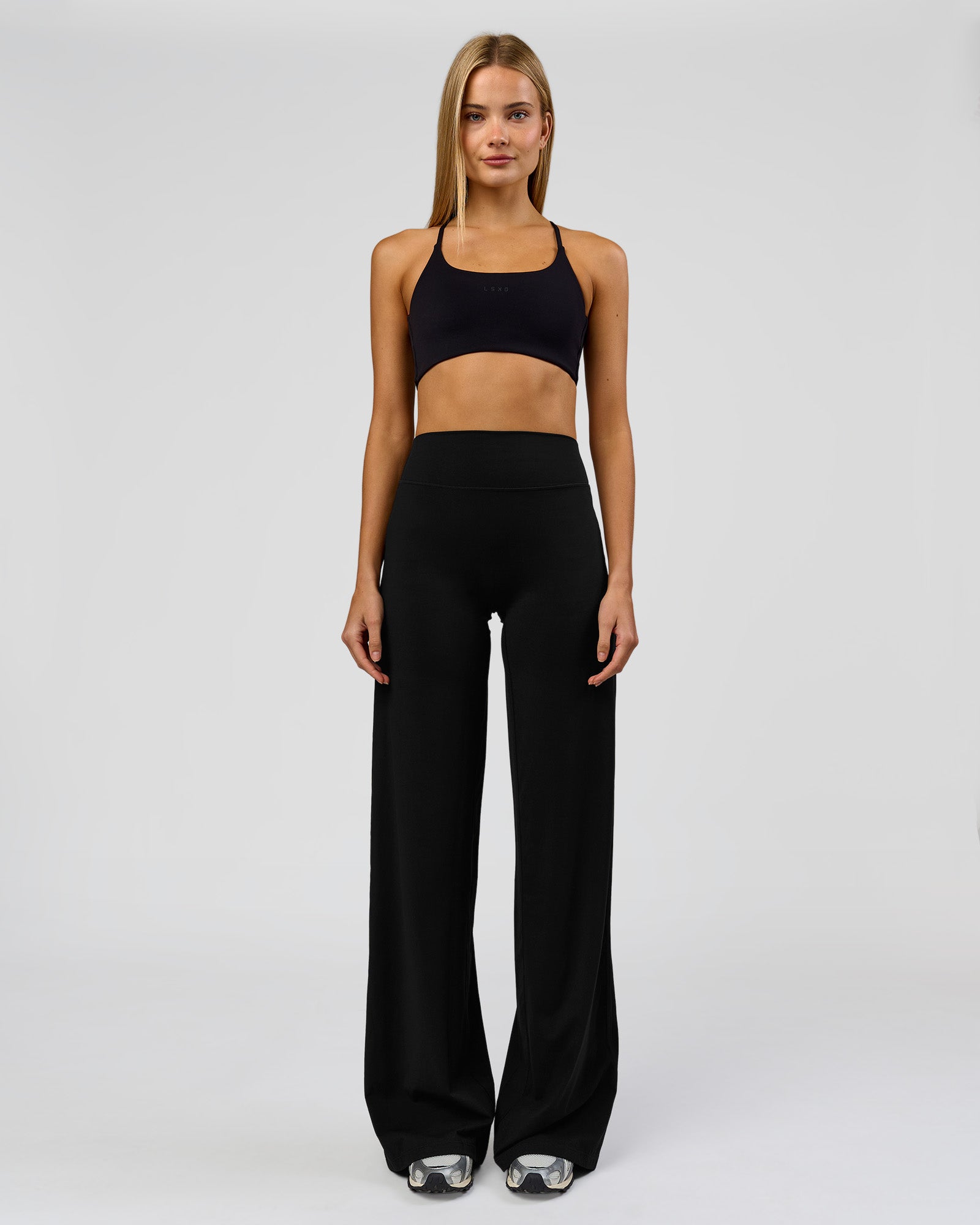 Woman wearing Elixir High-Rise Tall Pant - Black | Model:Taneisha | Size:XS