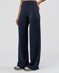 Woman wearing Elixir High-Rise Tall Pant - Midnight Navy | Model:Taneisha | Size:XS | Thumbnail Index: 1