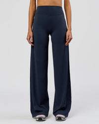 Woman wearing Elixir High-Rise Tall Pant - Midnight Navy | Model:Taneisha | Size:XS | Thumbnail Index: 7