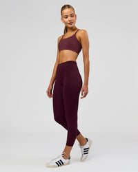 Woman wearing Fusion High-Rise 7/8 Legging Pockets - Cherry Lacquer | Model:Taneisha | Size:XS | Thumbnail Index: 1