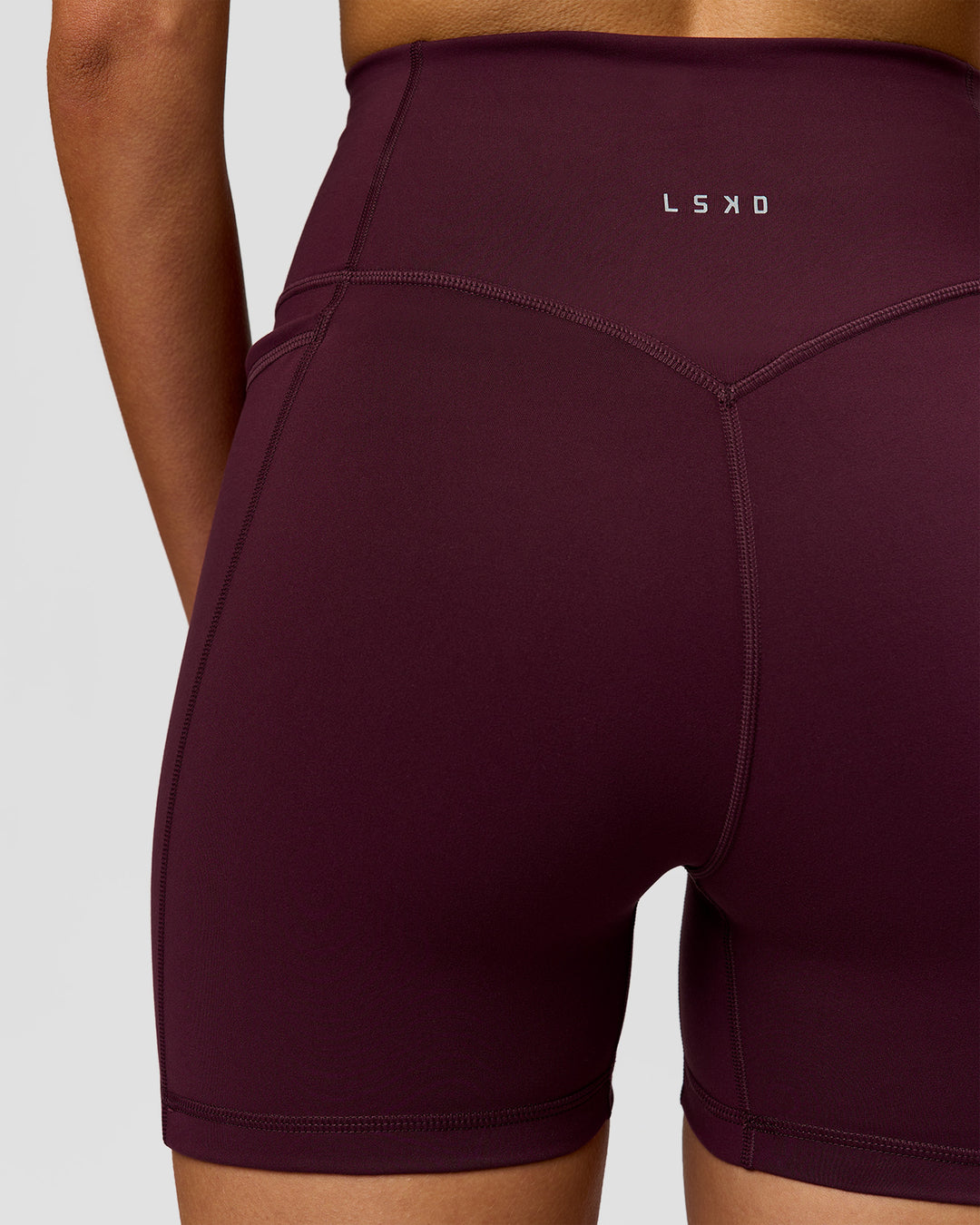 Woman wearing Fusion V-Contour Ultra High-Rise 4" Short Pockets - Cherry Lacquer | Model:Taneisha | Size:XS - view 4