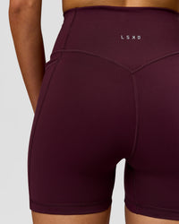Woman wearing Fusion V-Contour Ultra High-Rise 4" Short Pockets - Cherry Lacquer | Model:Taneisha | Size:XS | Thumbnail Index: 3