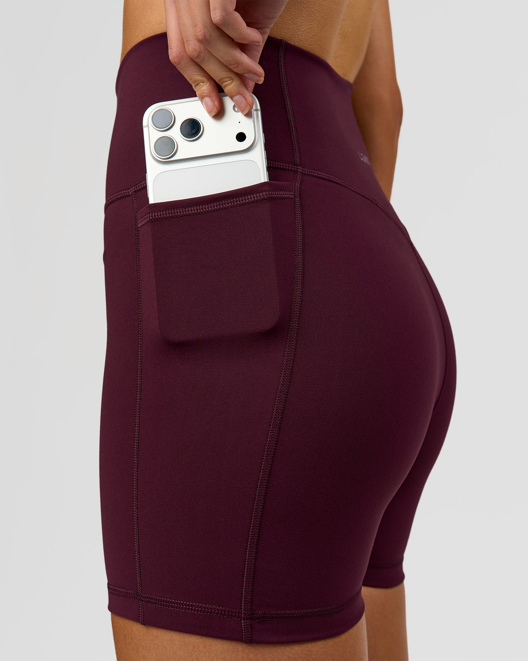 Woman wearing Fusion V-Contour Ultra High-Rise 4" Short Pockets - Cherry Lacquer | Model:Taneisha | Size:XS - view 9